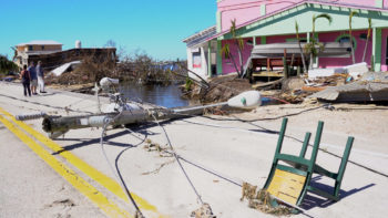 Debris from Hurricane Ian, including a downed light pole, are seen in a town